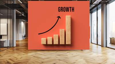 wooden blocks as a graph with the word GROWTH on orange background Wall mural