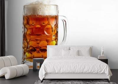 A clear glass filled with dark beer and topped with creamy foam Wall mural