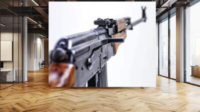 A close-up shot of a machine gun on a white background, suitable for use in military or war-related contexts Wall mural