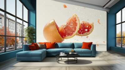 A fresh grapefruit falls from above and sinks slowly into the water, with ripples forming on the surface Wall mural