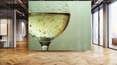 A glass of white wine on a table, perfect for wine-related designs Wall mural