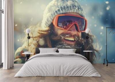 A man with long hair and a beard is pictured wearing ski goggles. This image can be used to depict a winter sports enthusiast or someone preparing for a skiing or snowboarding adventure Wall mural