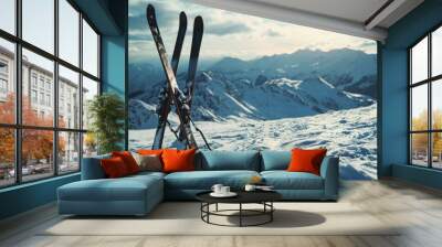 A pair of skis resting on top of a snow-covered slope. Perfect for winter sports or outdoor adventure themes Wall mural