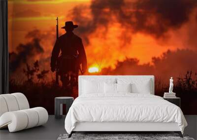 A person holding a rifle in an open field, suitable for outdoor or hunting themes Wall mural