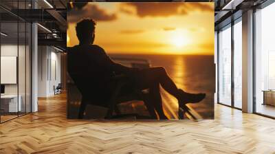 A person sitting in a chair enjoying the sunset view Wall mural