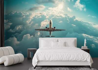 A plane flying high above fluffy white clouds Wall mural