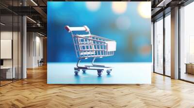 A small shopping cart is placed on top of a table. Perfect for illustrating concepts related to shopping, consumerism, retail, or e-commerce Wall mural