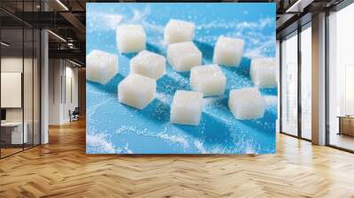 A stack of sugar cubes on a bright blue background, great for use in food and beverage related contexts Wall mural