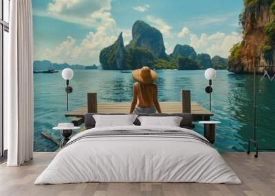 A woman sitting on a dock looking out at the water. Suitable for travel and relaxation themes Wall mural