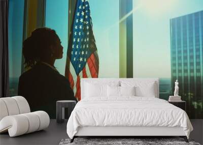 A woman stands in front of a window with an American flag, a symbol of patriotism and national pride Wall mural