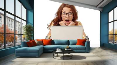 A woman wearing glasses looks at a laptop screen, possibly researching or working Wall mural