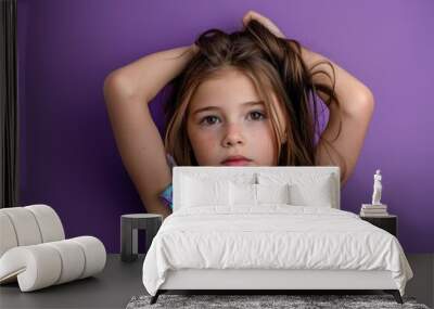 A young girl holds her long brown hair back, possibly getting ready for a special occasion Wall mural