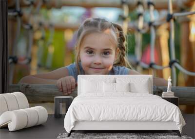 A young girl stands atop a wooden structure, looking out at the surrounding environment Wall mural