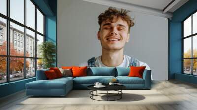 A young man smiling with his eyes closed. Suitable for various concepts Wall mural