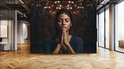 Beautiful girl folded her hands in prayer. Wall mural