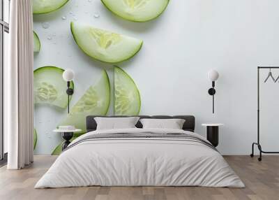 Fresh cucumber slices arranged neatly on a white surface Wall mural