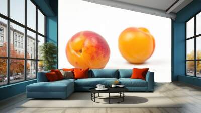 Fresh peaches sit adjacent on a clean white surface, perfect for still life photography or fruit display Wall mural