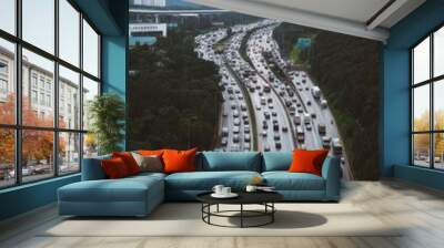 Highway congestion near tall city buildings, a common urban scene Wall mural