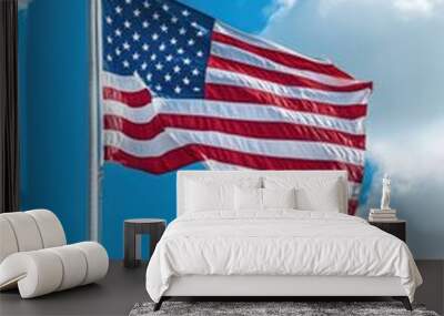 Large American flag waving high in the clear blue sky Wall mural