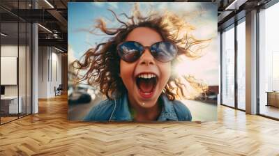 Laughing curly-haired child close-up Wall mural