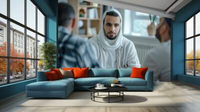 Two men wearing headscarfs having a conversation, possibly discussing plans or sharing information Wall mural