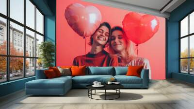 Two women hold heart-shaped balloons, symbolizing friendship or love Wall mural