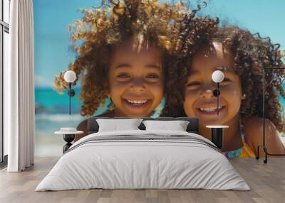 Two young girls stand together on a sunny beach, enjoying the outdoors Wall mural