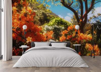 Vibrant orange flowers bush against a clear blue sky. Ideal for nature or gardening concepts Wall mural