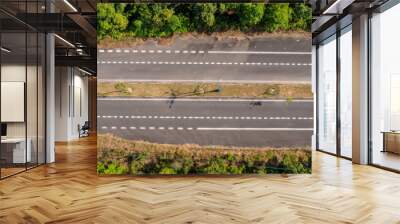 Aerial view of a deserted four-lane highway with surrounding greenery, Empty road, Sunny day Wall mural