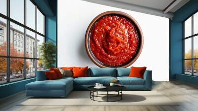 Bowl of vibrant red tomato sauce isolated on a white background, top view, perfect circular shape  Wall mural