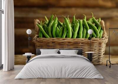 Fresh green beans in a wicker basket on a rustic wooden stall background warm lighting  Wall mural