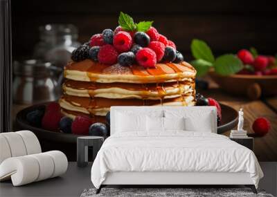 Inviting stack of pancakes adorned with syrup and berries on rustic table  Wall mural