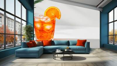 Minimalist Aperol spritz isolated on a white background with ice cubes and an orange slice floating  Wall mural