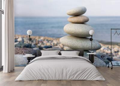 Stack of zen stones in harmony and balance with sea view Wall mural