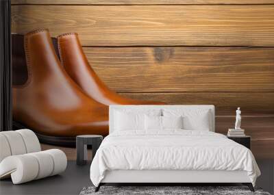 Tan leather ankle boots with a subtle distressed finish isolated on a rustic wooden backdrop  Wall mural