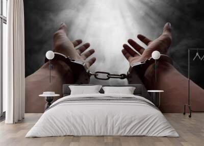 Hands of prisoner in handcuffs Wall mural