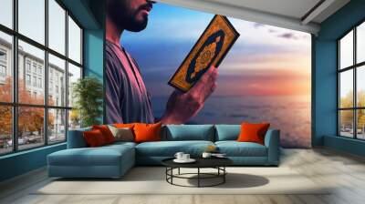 Muslim man reading holy quran Wall mural