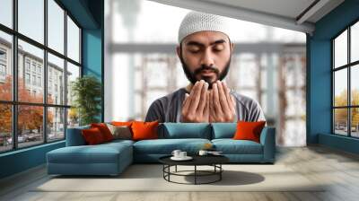 Religious asian muslim man praying Wall mural