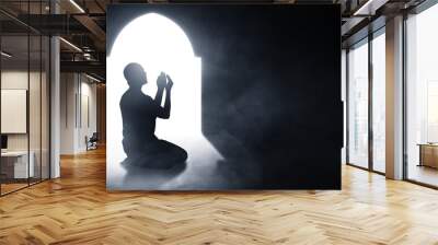 Silhouette of muslim man praying Wall mural