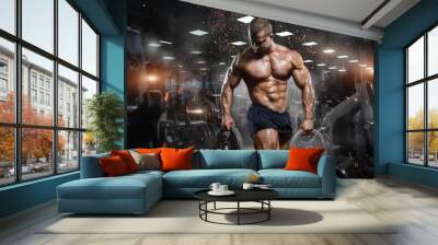 muscular athletic bodybuilder fitness model posing after exercises in gym Wall mural