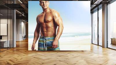 sexy caucasian fit man posing in a beach Wall mural