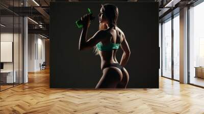 young sexy woman with perfect fitness body drinking water Wall mural