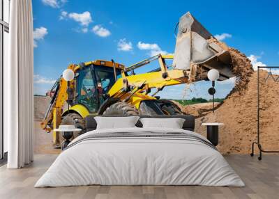 excavator machine unloading sand during earth moving works Wall mural