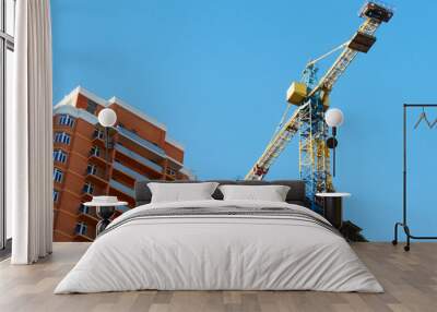 crane and building against blue sky. construction site background. commercial building project Wall mural