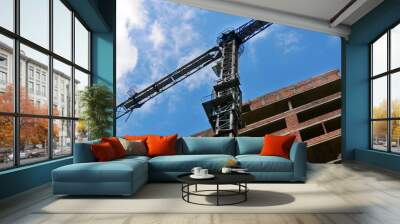 Crane near building. Construction site background. Wall mural