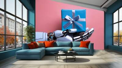  Robotic Hand Holding a Blue Gift Box with Ribbon on Pink Background- A sleek, robotic hand _1(319) Wall mural