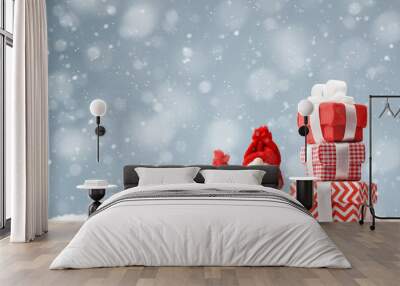 Christmas gnomes with gift boxes on the snow background Wall mural