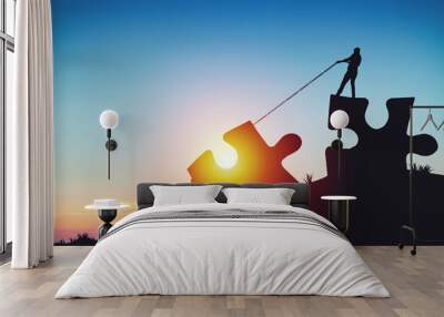 People silhouettes putting puzzle pieces together on sunlight background Wall mural