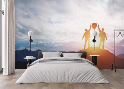 Silhouette man holding up a gold trophy cup. Wall mural