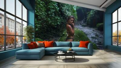 Beautiful girl with a sexy body among tropical jungle
 Wall mural